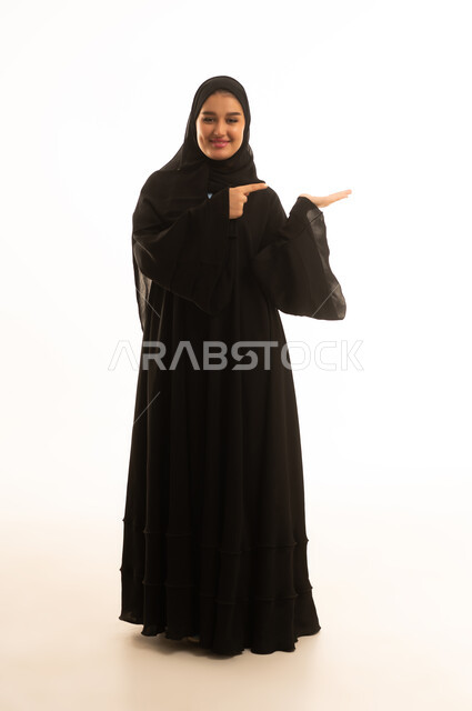 Saudi Woman in Abaya Pointing at Palm White Background