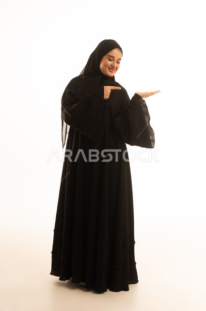 Saudi Woman in Black Abaya Presenting Product Studio