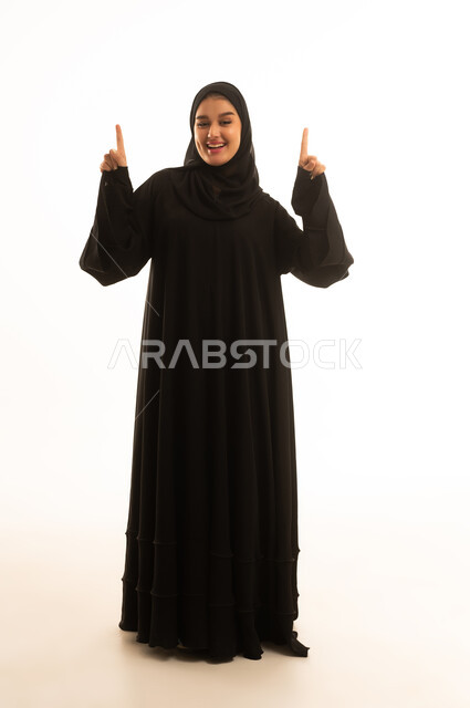 Saudi Woman in Black Abaya Pointing Up White Background