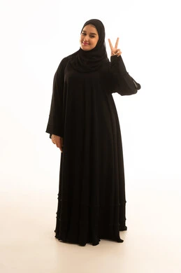 Saudi Woman in Abaya Making Peace Sign on White Background