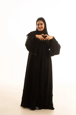 Saudi Woman in Black Abaya Making Heart Gesture
