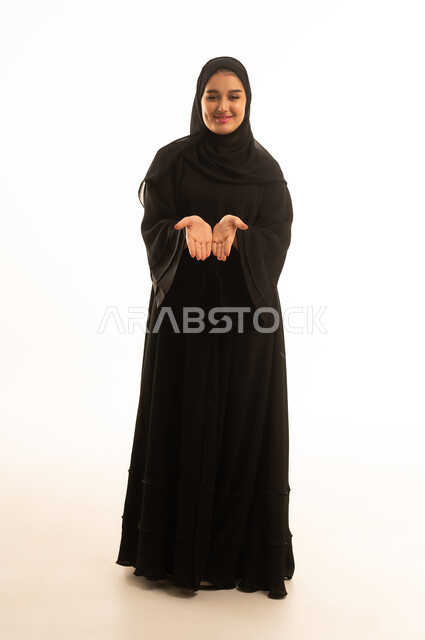 Saudi Woman in Black Abaya Holding Palms Upward