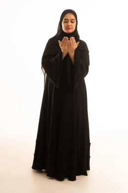 Saudi Woman in Black Abaya Praying on White Background Saudi Woman in Black Abaya Praying on White Background