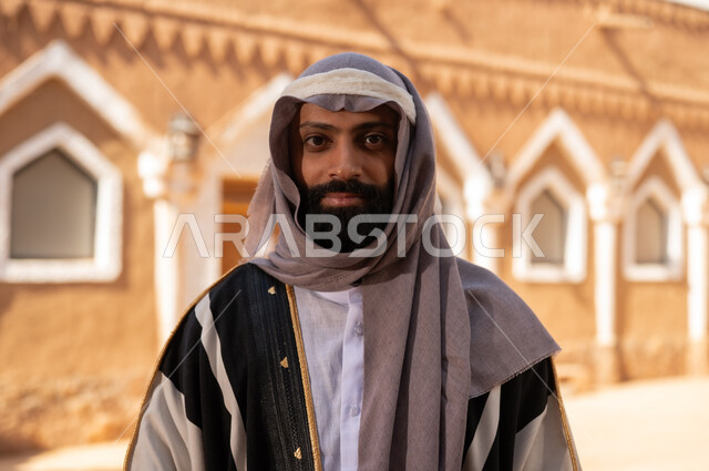 An Arab Saudi Gulf man wearing the attire of the Foundation Day, embodying masculinity and authenticity, commemorating the establishment of the first Saudi state by Imam Muhammad bin Saud, on the day we began, February 22, 1727 AD, the historical and cultural depth of the Kingdom, national celebrations in the central region.