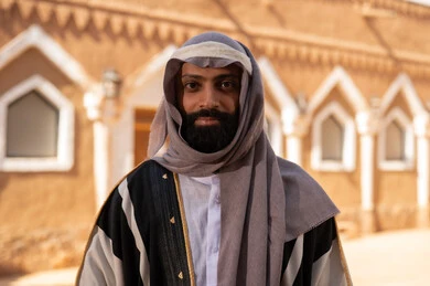 An Arab Saudi Gulf man wearing the attire of the Foundation Day, embodying masculinity and authenticity, commemorating the establishment of the first Saudi state by Imam Muhammad bin Saud, on the day we began, February 22, 1727 AD, the historical and cultural depth of the Kingdom, national celebrations in the central region.