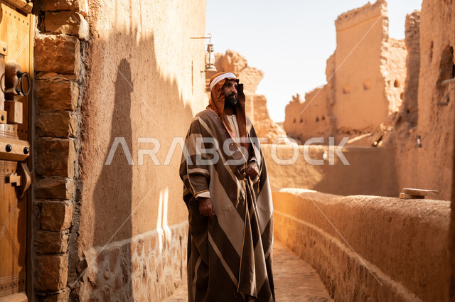 An Arab Saudi Gulf man wearing the founding day attire stands with pride and dignity in the history of the Kingdom, commemorating the establishment of the first Saudi state by Imam Muhammad bin Saud, on the day we began, February 22, 1727. The historical and civilizational depth of the Kingdom is the identity of Saudi National Day 92.