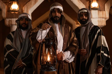 A popular neighborhood with traditional mud houses, a holiday and a national occasion, the anniversary of the founding of the first Saudi state on February 22, showing love and loyalty to the state and the homeland, three Arab Gulf Saudi men wearing traditional folk attire, a lit traditional lantern, pride and honor in national identity, the day we began in 1727 AD.
