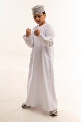 Omani Boy in Traditional Dress Fighting Pose Studio