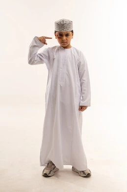 Omani Boy with Bruised Eye in Traditional Clothing