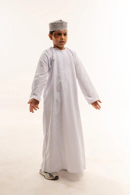 Omani Boy in Traditional Dishdasha and Kummah