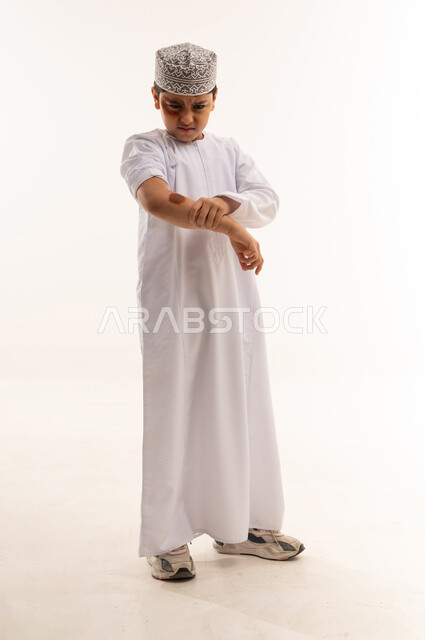 Omani Boy in Traditional Dress with Bruised Face