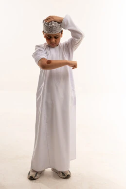 Omani Boy in Traditional Dishdasha on White Background