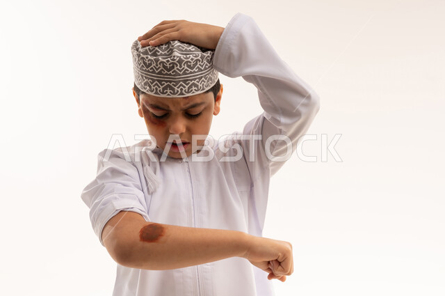 Injured Omani Boy with Bruises in Traditional Clothing