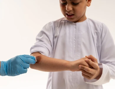 Saudi Boy Receiving First Aid for Arm Injury