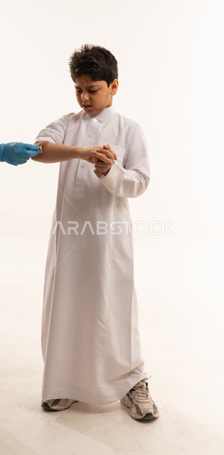 Saudi Boy Receiving Medical Treatment on White Background