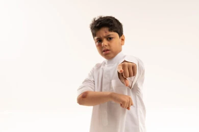 Angry Saudi Boy with Bruises Pointing Finger