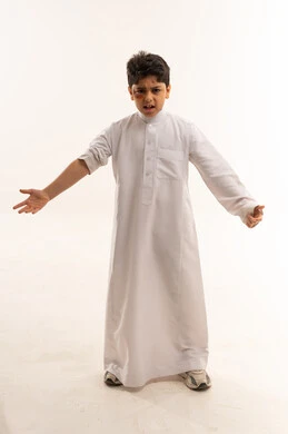 Angry Saudi Boy with Bruised Eye in White Thobe
