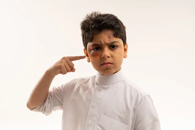 Young Saudi Boy with Facial Bruise Studio Portrait