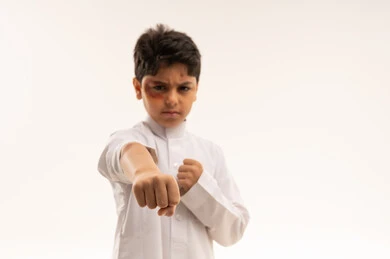 Arab Boy in White Thobe Punching with Bruised Eye