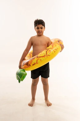 Saudi Boy with Pineapple Swim Ring on White Background