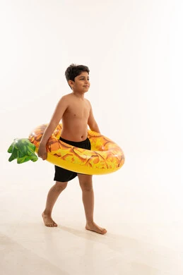 Arab Boy with Pineapple Inflatable Swim Ring in Studio