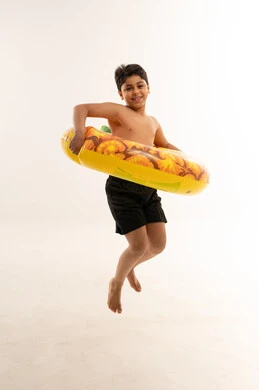 Arab Boy Jumping with Yellow Swim Ring Studio