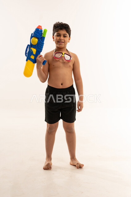 Saudi Boy with Water Gun in Studio Setting