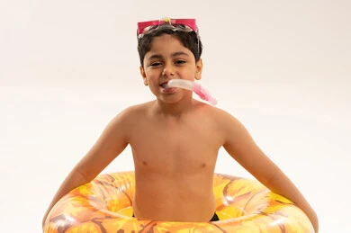 A Saudi child with diving gear and a swimming ring.