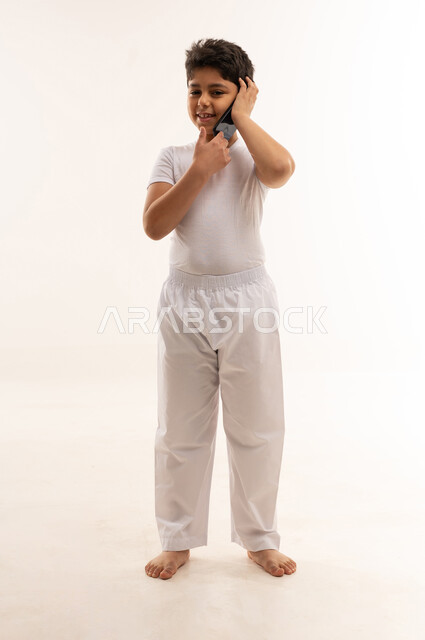 Arab Boy Talking on Smartphone White Background