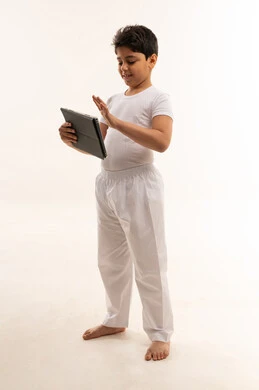 Arab Boy Using Digital Tablet in Studio