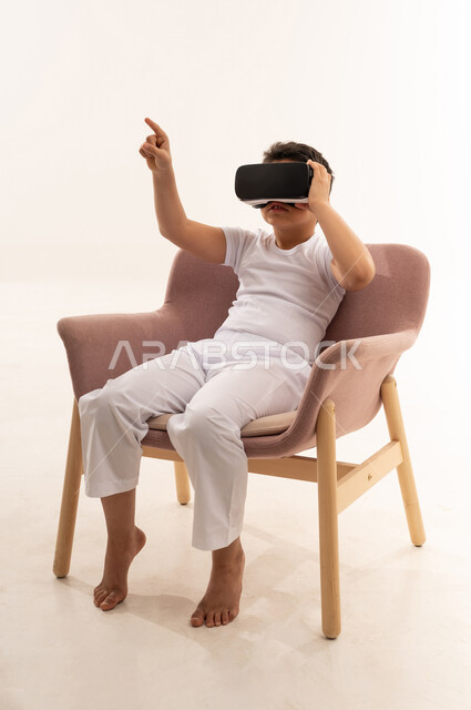 Saudi Boy Using VR Headset on White Background