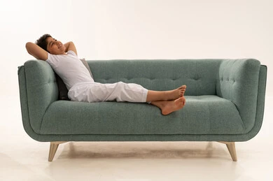 Arab Boy Relaxing on Green Modern Sofa