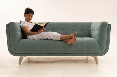 Saudi Boy Reading Book on Modern Green Sofa