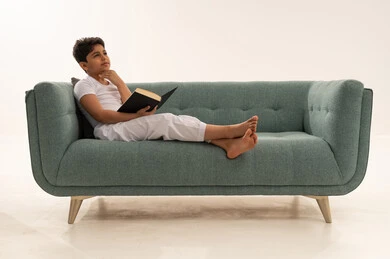 Saudi Boy Reading and Thinking on Sofa