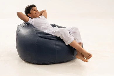 Saudi Boy Relaxing on Blue Bean Bag in Studio