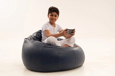 Arab Boy with Smartphone on Blue Bean Bag Studio