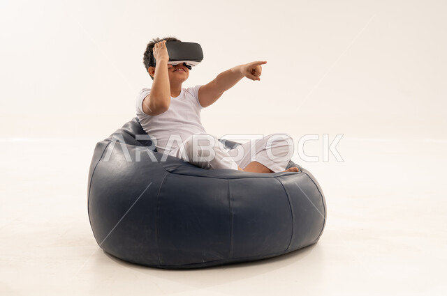 Arab Boy Using Virtual Reality Headset in White Studio