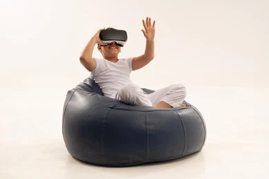 Arab Boy Using Virtual Reality Headset on Bean Bag
