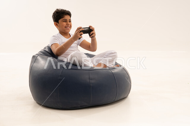 Saudi Boy Playing Video Games on Beanbag Studio