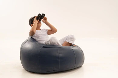 Middle Eastern Boy with Binoculars on Blue Bean Bag