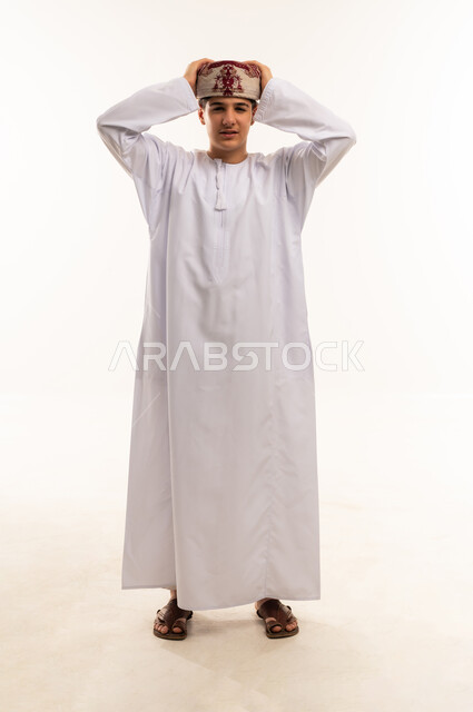 Omani Boy in Traditional White Dishdasha and Kummah