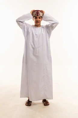 Omani Boy in Traditional White Dishdasha and Kummah