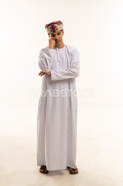 Omani Teenage Boy in Traditional Dishdasha and Kumma