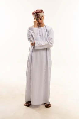 Pensive Young Omani Man in Traditional Dress White Background
