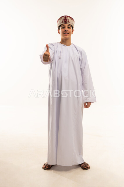 Omani Boy in Traditional Dishdasha Thumbs Up