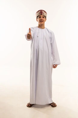 Omani Boy in Traditional Dishdasha Thumbs Up