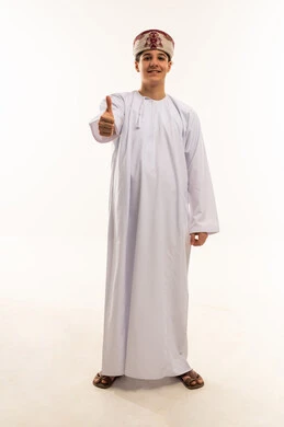Omani Boy in Traditional Dishdasha Thumbs Up
