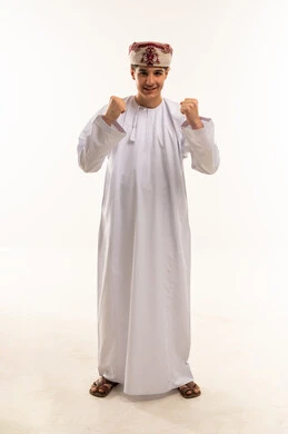 Omani Boy in Traditional Dishdasha Celebrating Success