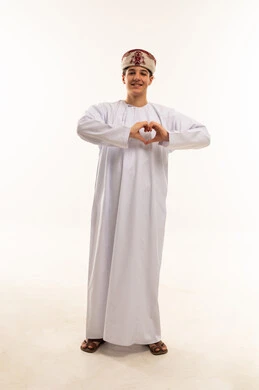 Omani Male in Traditional Dishdasha Making Heart Gesture