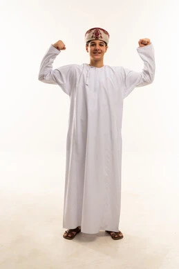 Omani Boy in Traditional Dress Flexing Muscles